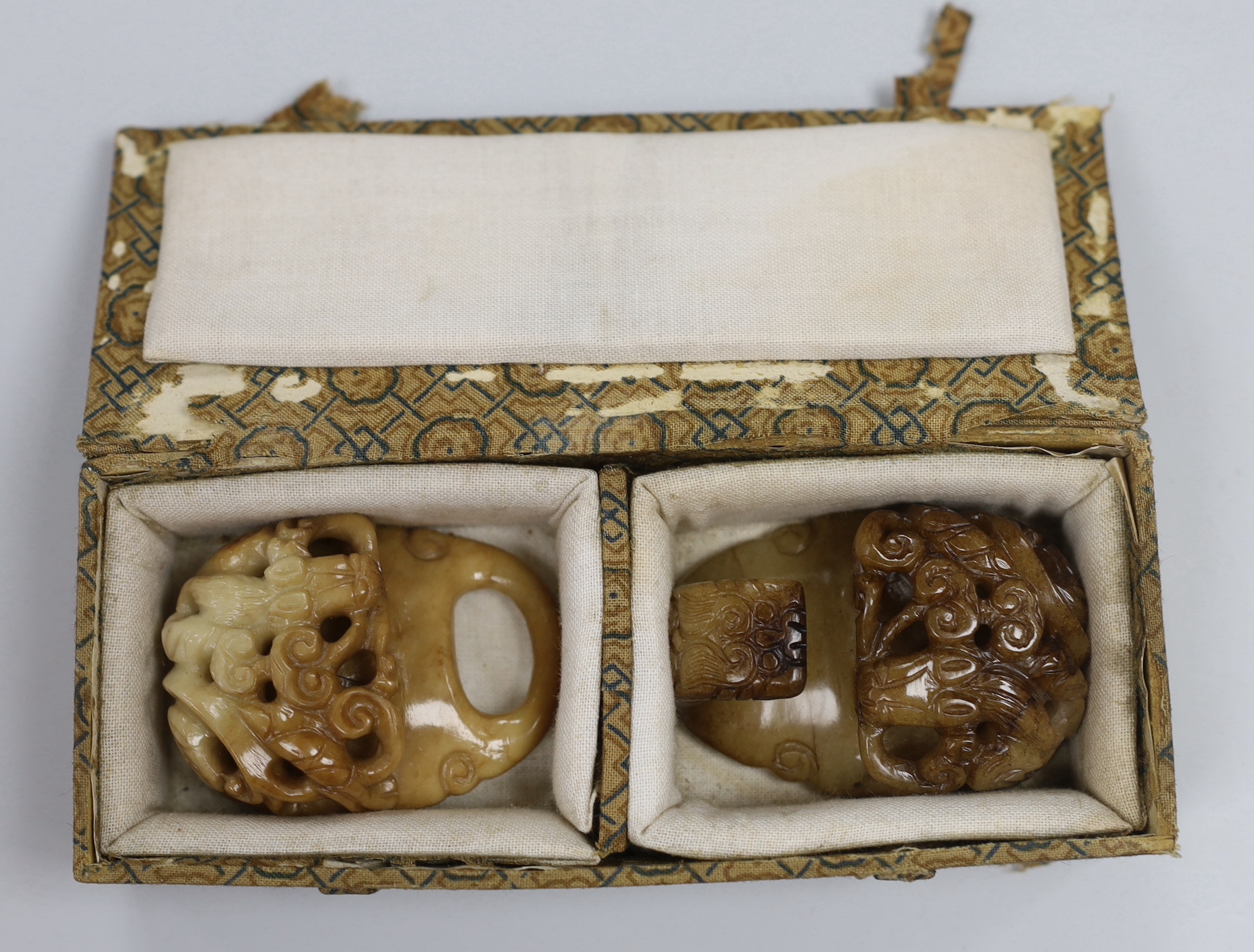 A Chinese cream and russet jade two piece belt buckle, 17th century